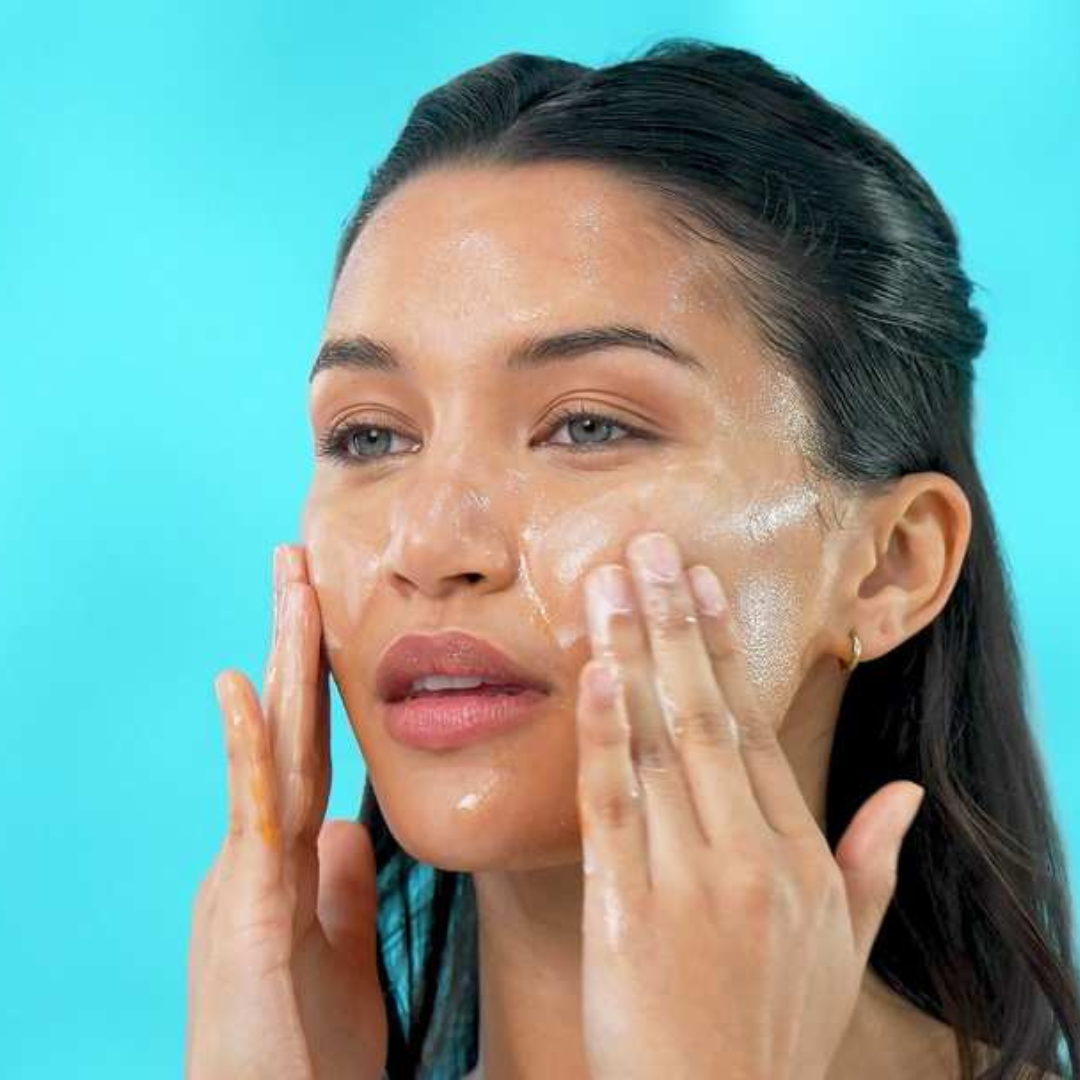 Official TEMPLESPA screen capture from a how-to video showing a model applying TEMPLESPA EASY GLOWING Vitamin C Facial Cleanser as part of a glowing skin routine