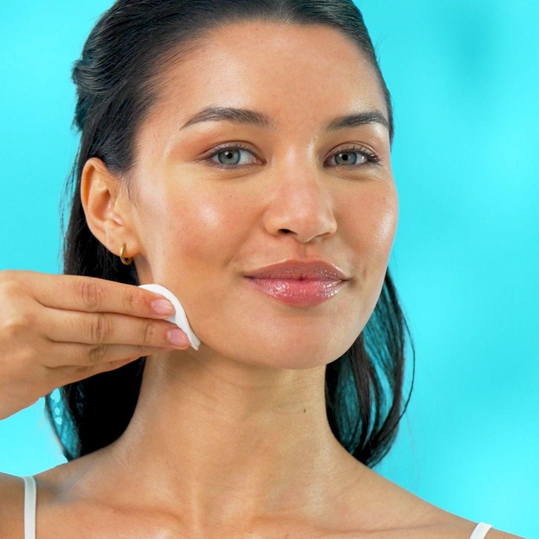 Official TEMPLESPA screen capture from a how-to video showing a model applying TEMPLESPA GLOWCOLIC Resurfacing Glycolic Acid Toner as part of a glowing skin routine