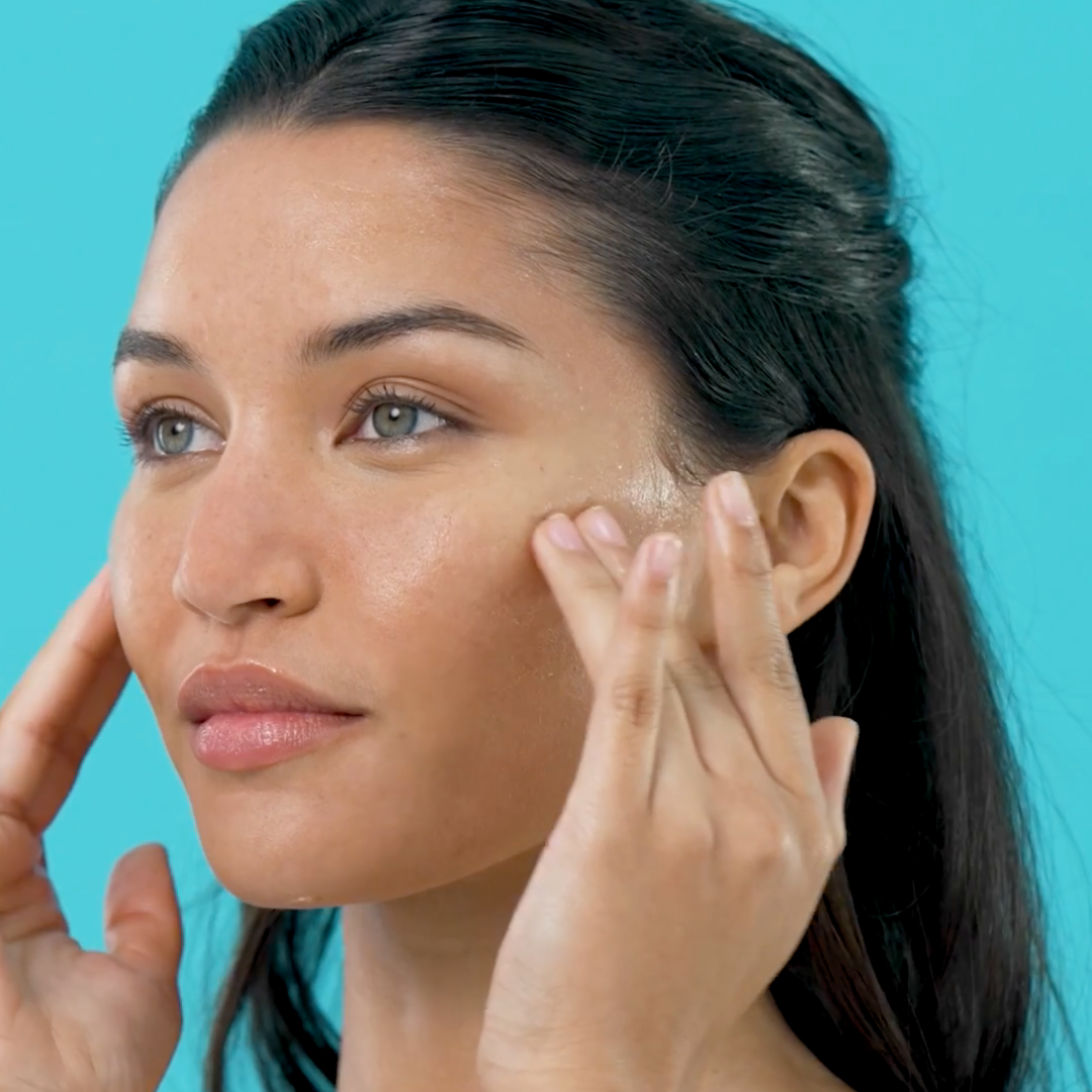 Official TEMPLESPA screen capture from a how-to video showing a model applying TEMPLESPA MOISTURE TO GLOW Radiance Moisturiser as part of a glowing skin routine